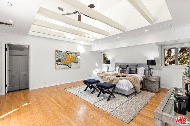 bedroom with a closet, crown molding, and hardwood / wood-style floors