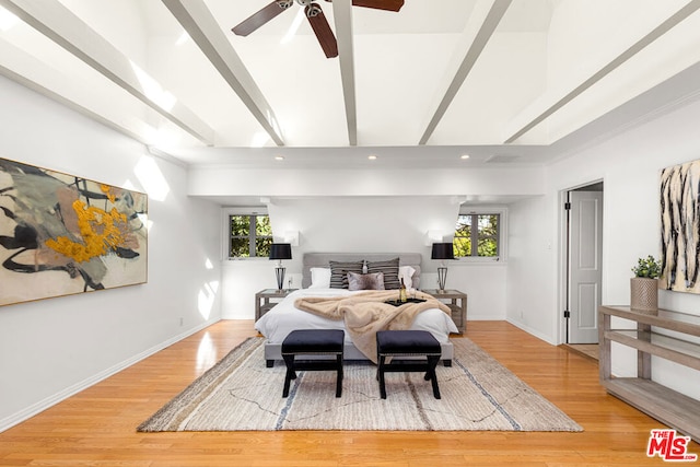 bedroom featuring ceiling fan, beamed ceiling, and light hardwood / wood-style flooring