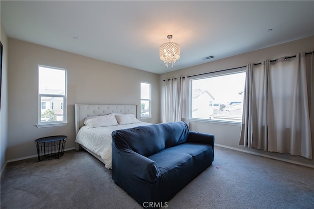 bedroom featuring visible vents, carpet flooring, and multiple windows