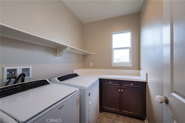 laundry area with washing machine and clothes dryer and cabinet space