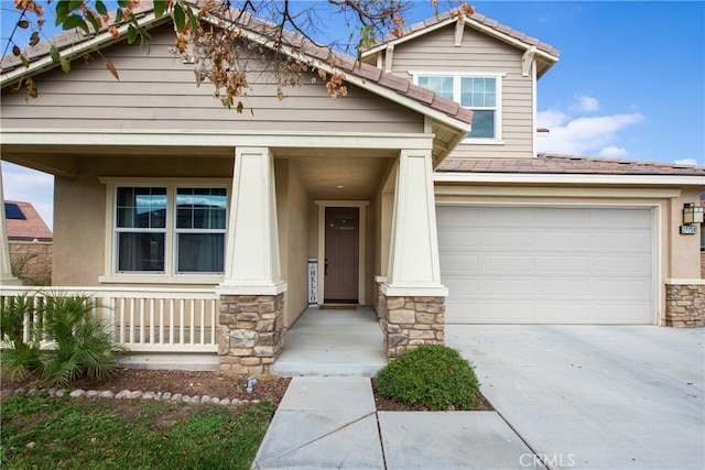 craftsman-style home with a porch, a garage, stone siding, concrete driveway, and stucco siding