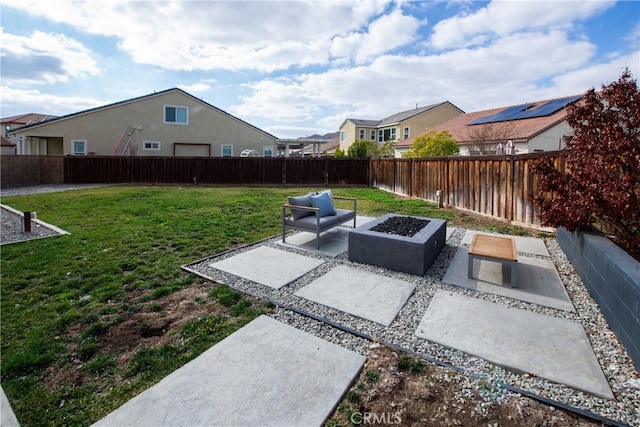 view of yard featuring a residential view, a fenced backyard, a patio, and a fire pit