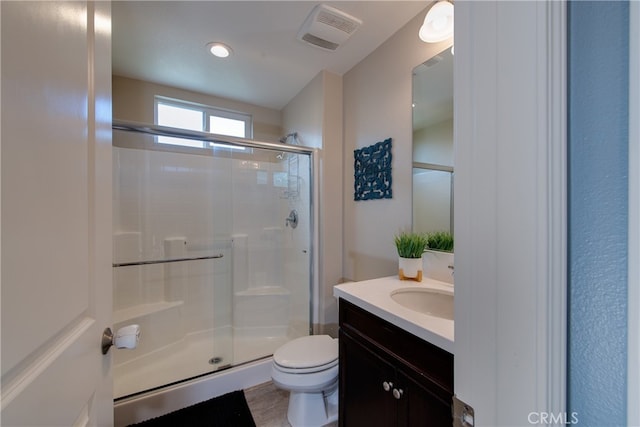 full bathroom featuring toilet, a stall shower, visible vents, and vanity