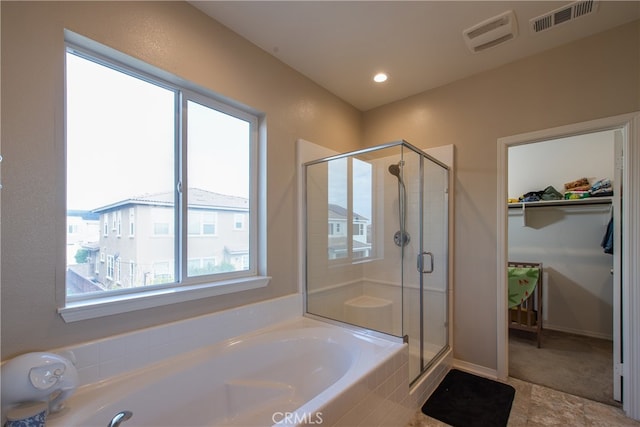 bathroom featuring a garden tub, a shower stall, and visible vents