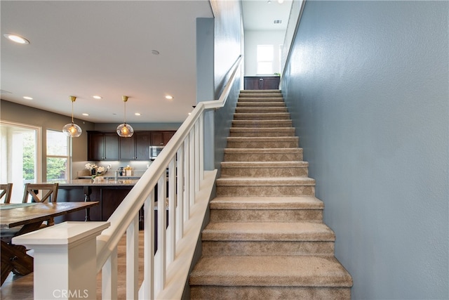 stairway featuring recessed lighting