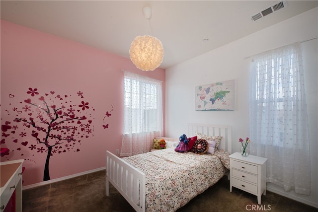 bedroom featuring dark carpet, visible vents, and baseboards