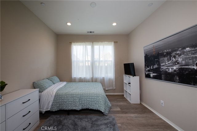 bedroom with baseboards, visible vents, wood finished floors, and recessed lighting