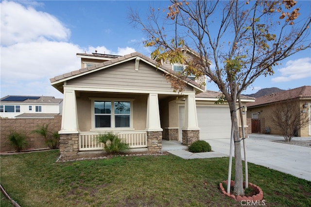 craftsman-style home with covered porch, a front yard, concrete driveway, and stucco siding