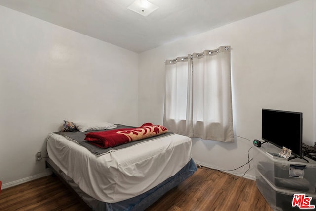 bedroom featuring dark hardwood / wood-style flooring