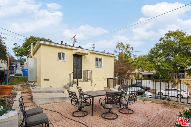 rear view of property featuring a patio