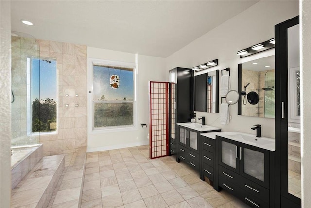 bathroom with a relaxing tiled tub and vanity