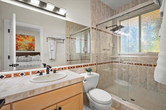 bathroom with walk in shower, vanity, and toilet