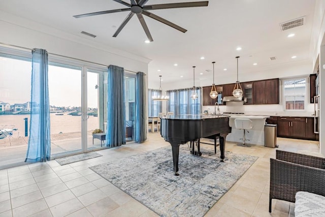 misc room with crown molding, a water view, light tile patterned floors, and ceiling fan