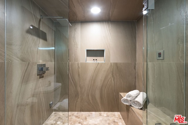 bathroom with tiled shower