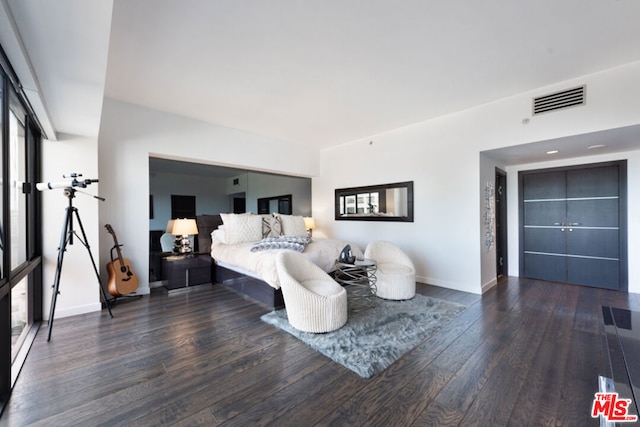 bedroom with dark hardwood / wood-style flooring