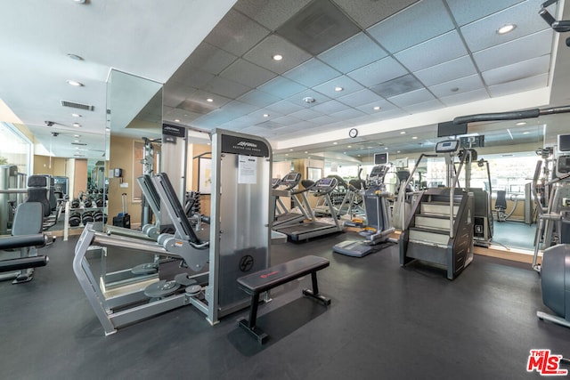 exercise room with a paneled ceiling