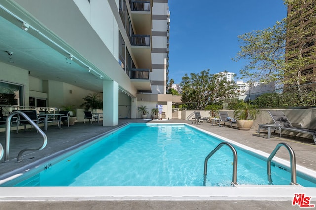 view of pool featuring a patio