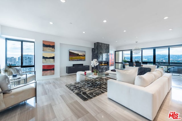 living room featuring an inviting chandelier and a healthy amount of sunlight