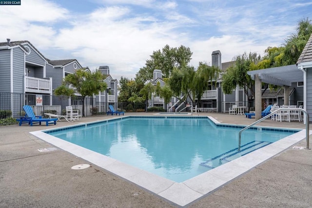 view of swimming pool featuring a patio and a pergola