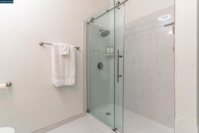 bathroom with a shower with shower door