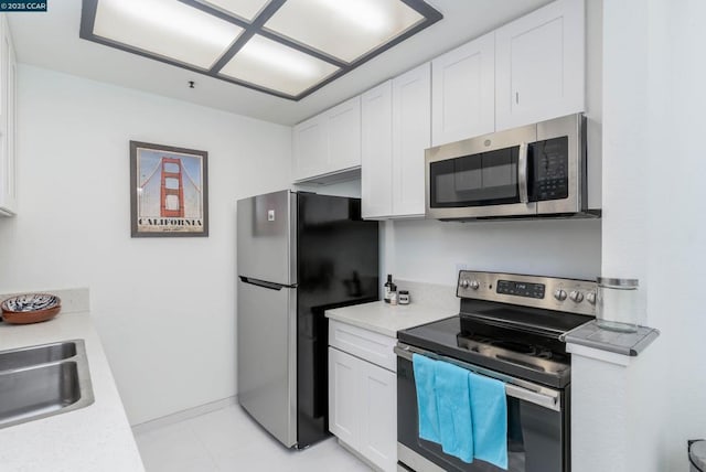 kitchen with white cabinets, appliances with stainless steel finishes, and sink