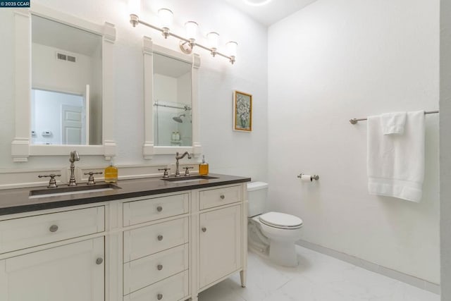 bathroom with toilet, vanity, and a shower