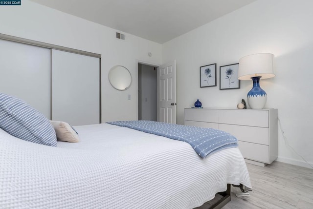 bedroom with a closet and light wood-type flooring