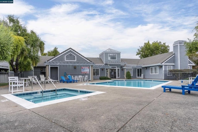 view of swimming pool with a patio area, a jacuzzi, and a pergola