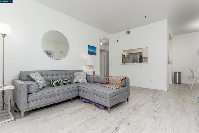 living room with light hardwood / wood-style flooring