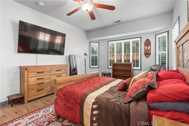 bedroom with ceiling fan and light hardwood / wood-style flooring