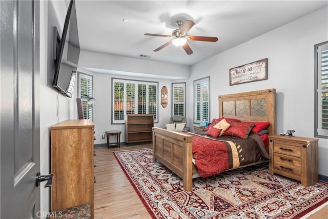 bedroom with ceiling fan and light hardwood / wood-style flooring