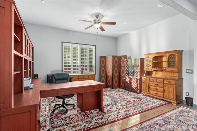 office space featuring ceiling fan and light wood-type flooring