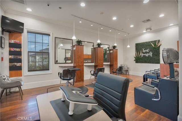 interior space with crown molding, dark hardwood / wood-style flooring, and track lighting