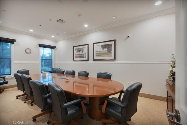 dining space featuring light colored carpet and ornamental molding