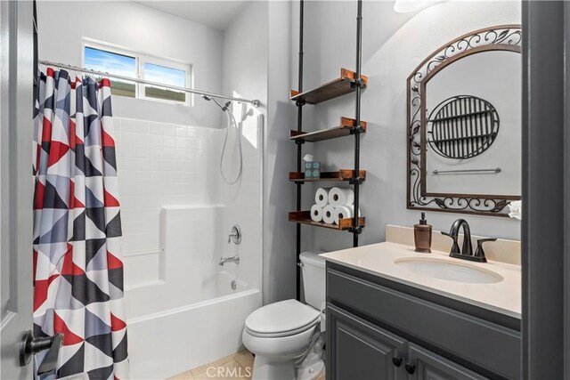 full bathroom featuring shower / bath combo with shower curtain, tile patterned floors, toilet, and vanity