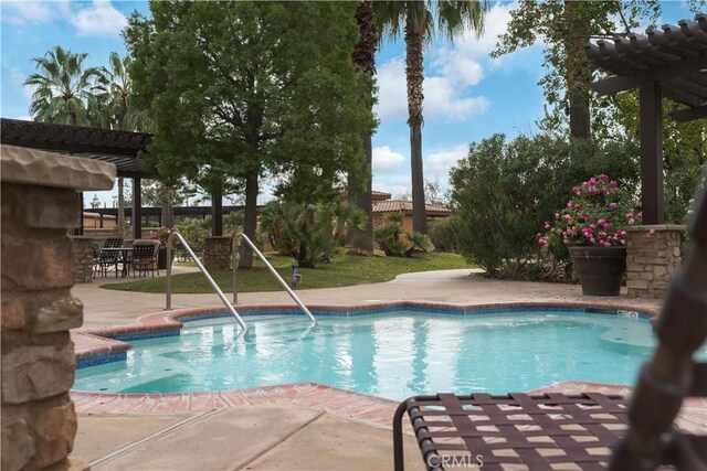 view of swimming pool with a pergola and a patio