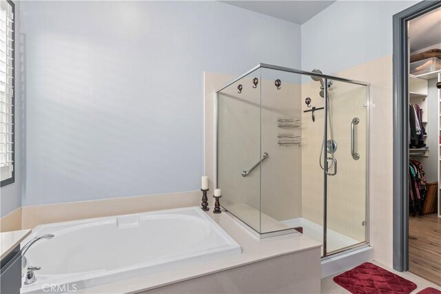 bathroom featuring a wealth of natural light, vanity, and independent shower and bath