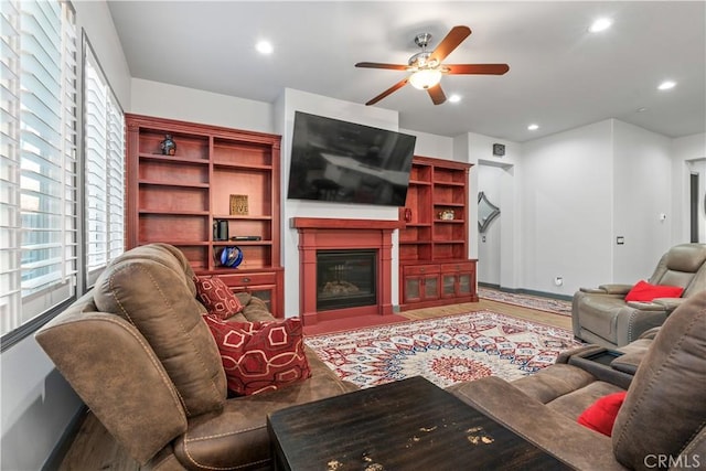 living room featuring ceiling fan and hardwood / wood-style flooring