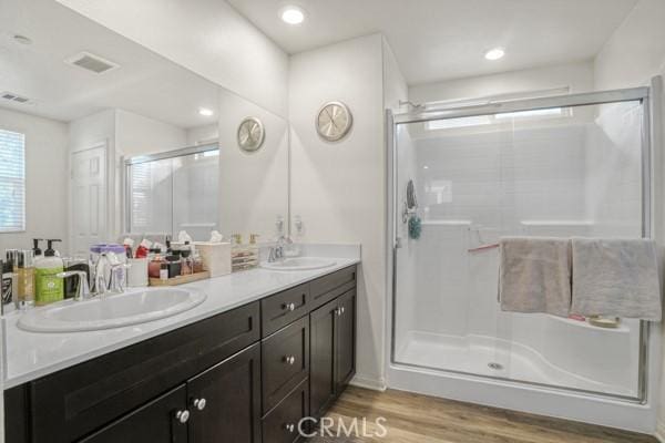 bathroom featuring vanity, hardwood / wood-style floors, and an enclosed shower