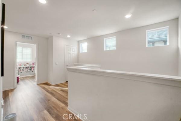 hallway with light hardwood / wood-style flooring