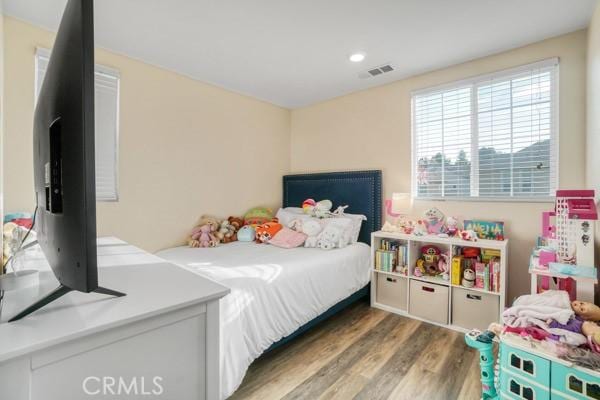 bedroom with dark wood-type flooring