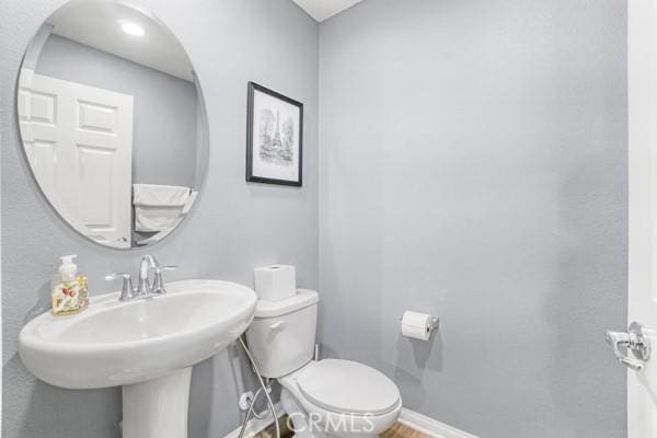 bathroom with toilet and sink