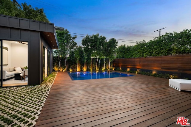 wooden terrace with a fenced in pool