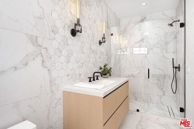 bathroom featuring an enclosed shower, vanity, tile walls, and toilet