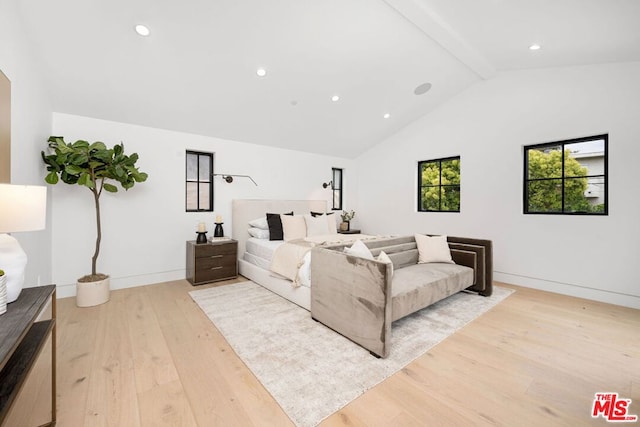 bedroom featuring light wood-type flooring, high vaulted ceiling, and beamed ceiling