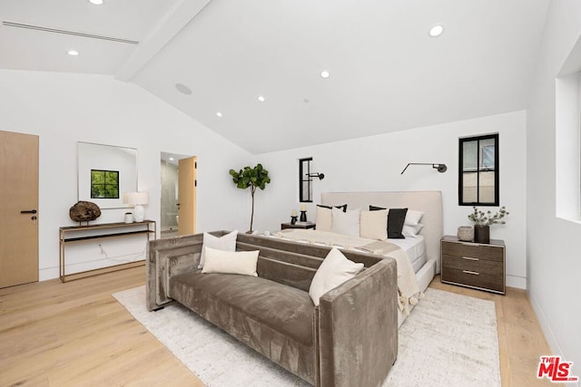 bedroom with vaulted ceiling with beams and light wood-type flooring