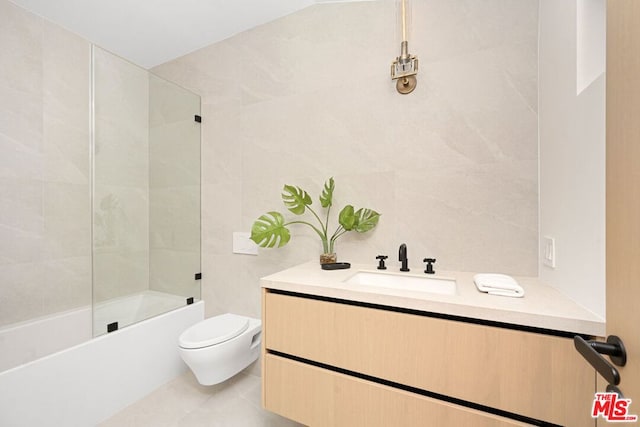 full bathroom featuring toilet, tile walls, tile patterned floors, tub / shower combination, and vanity