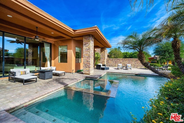 view of swimming pool with ceiling fan, an outdoor living space, and a patio