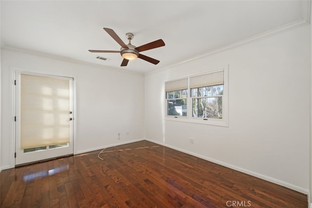 empty room with ornamental molding, dark wood-type flooring, and ceiling fan