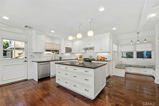 kitchen featuring hanging light fixtures, white cabinets, and appliances with stainless steel finishes